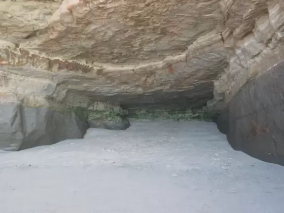 The cave where you can stand and hope not to get caught when the waves come tumbling in.