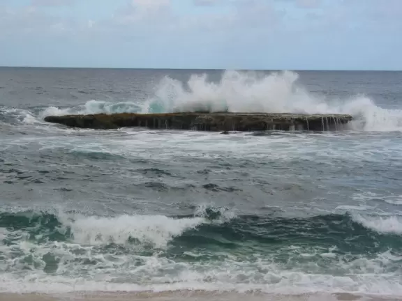 Water crashing on one of the "three tables."