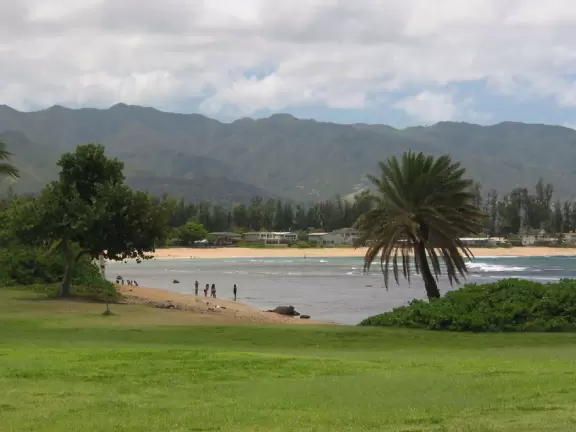 Walk west across the greenest lawn to another pretty beach.
