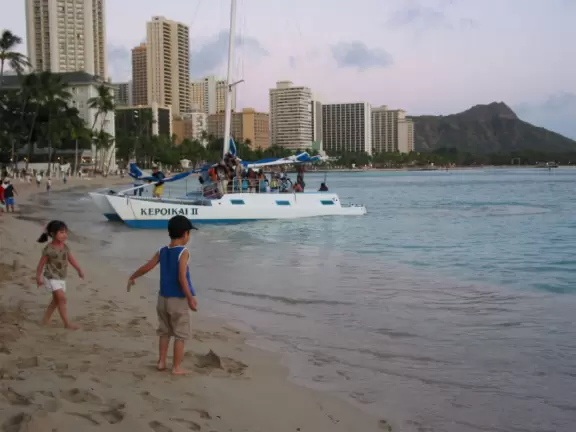 Playing in the tiny bouncing waves by the shore, in the evening.