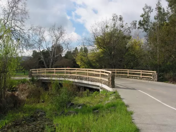 Cute bridge with stream below.