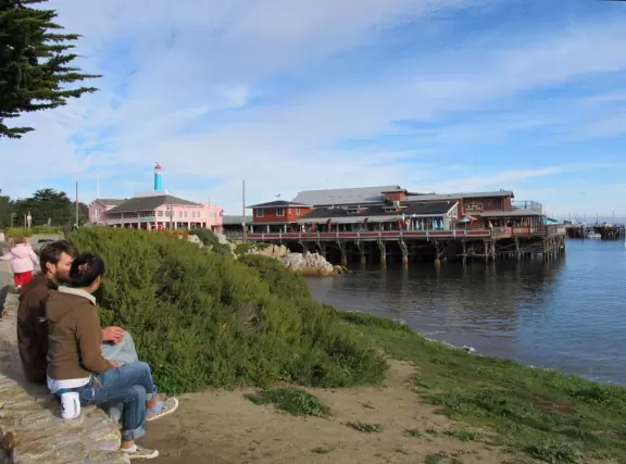 A couple sit and enjoy the tranquility at Monterey Harbor.