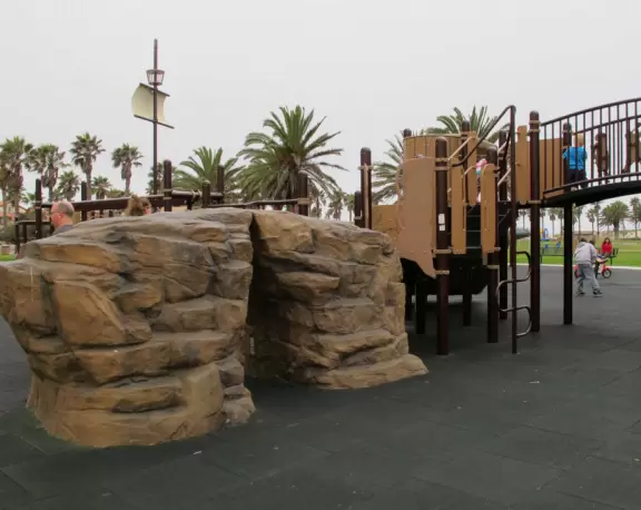 Rock climber and playground bridge with pirates on it.