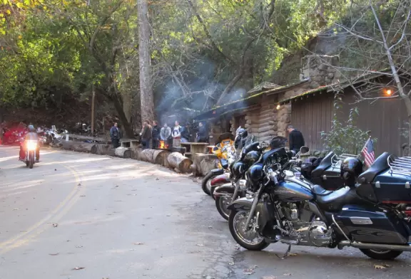 Bikers warm up by the fire on a Sunday afternoon.