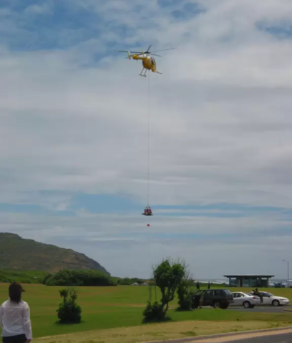 Lowering the rescued at the park across the parking lot from the beach.