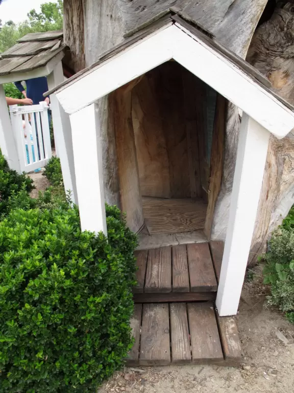 You crawl into a carved out tree trunk!