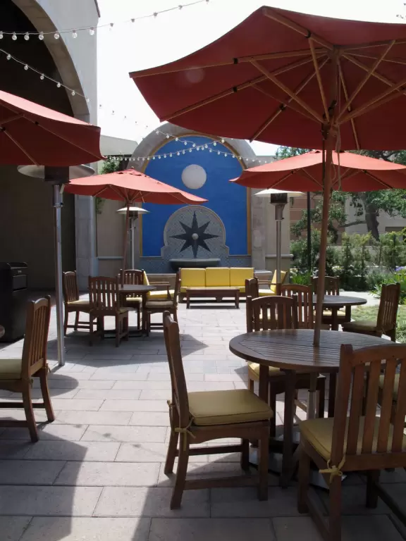 Seating with couches and wooden tables and chairs outside the food court.