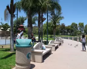 Lake, benches, and fenced playground.