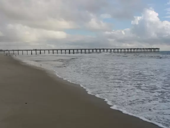 A wide expanse of desolate beach, with a wildly wonderful pier! This is not your average pier!