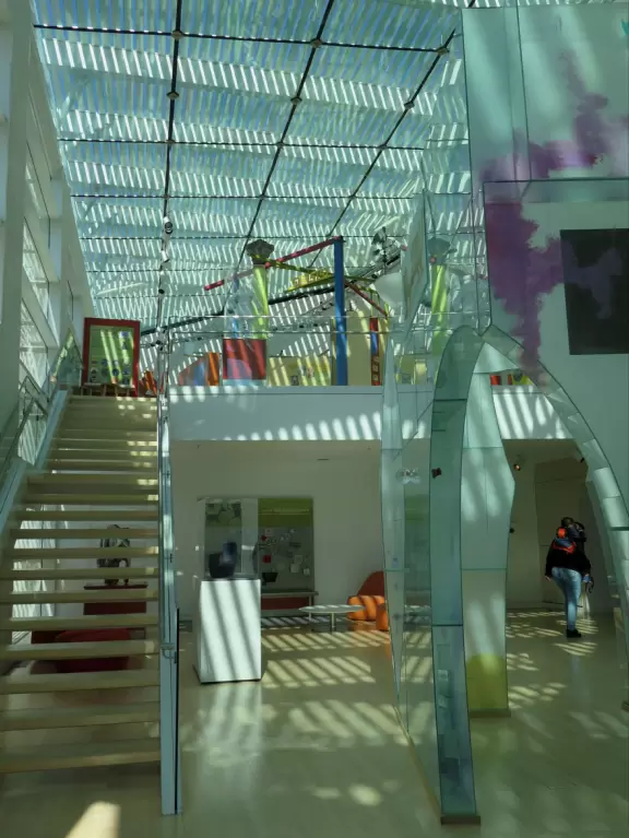 Incredible glass building with interesting activity stations for kids and modern art for parents.