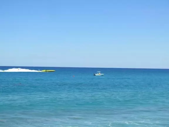 Yellow speed boat goes by.