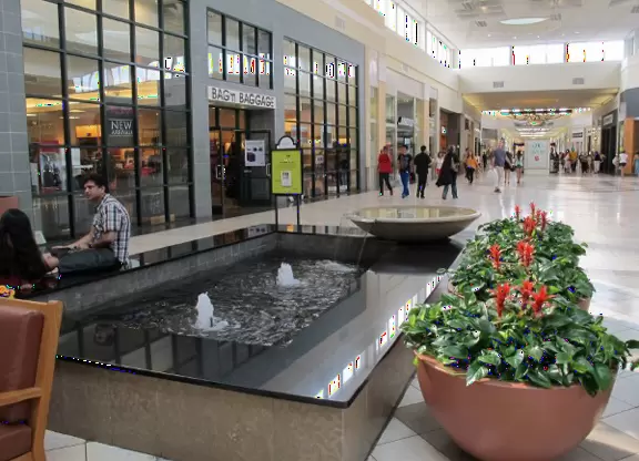 Indoor mall with sun canopies, decorative towers, fountains, and atriums.