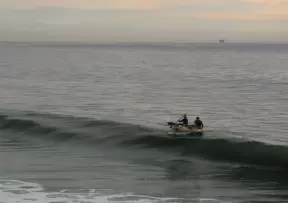 Surfers return to Gaviota Beach by dinghy after trying to sneak a few rides on waves at Hollister Ranch, just west of Gaviota Beach.
