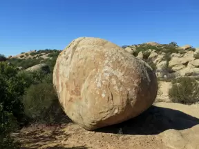 A round boulder and shadow.