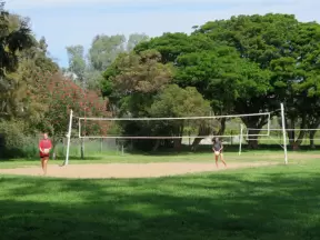 Two girls play volleyball.