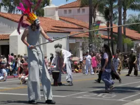 Man on stilts in the Summer Solstice Parade 2017.