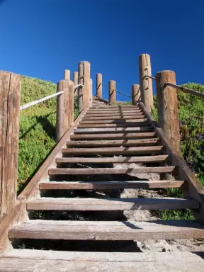 Wooden stairs that lead down to Jelly Bowl Beach. What a beautiful blue sky!