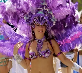 Samba dancer in purple feathered head dress in the 2011 Summer Solstice parade. Photo be Arturo G. Vega.