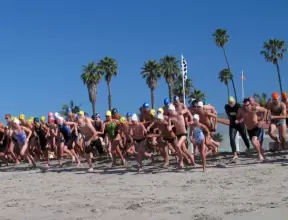 Swimmers bolt after they hear the buzzer at an East Beach swim meet.