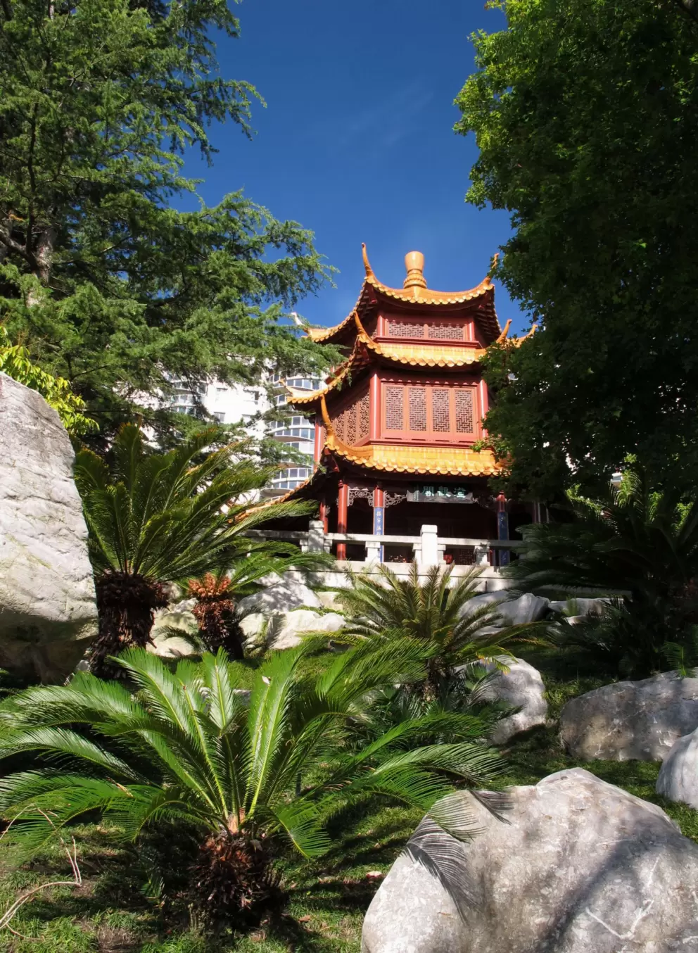 Pagoda, plants, and rocks.