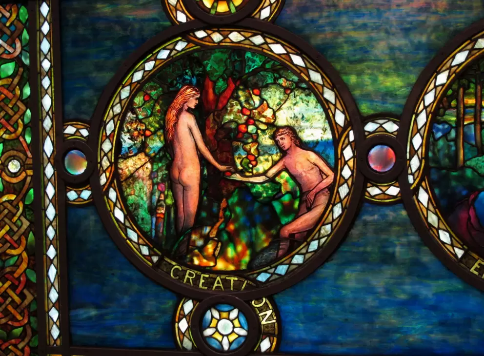 A sweet, little scene of Adam and Eve in stained glass.