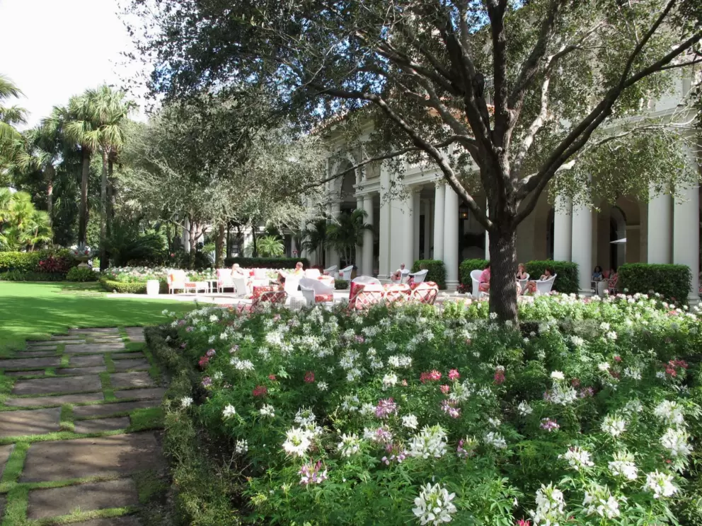 The Palm Courtyard, flowers, and lawn.