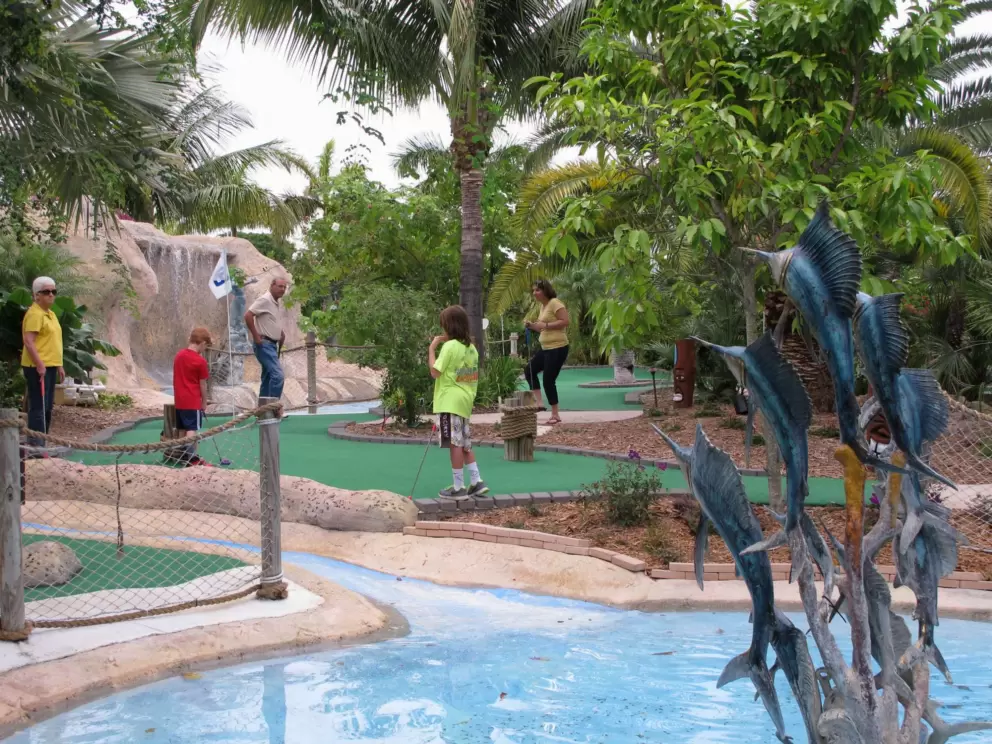 A family enjoys a Sunday morning game of mini golf.