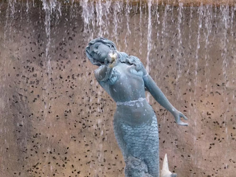 Mermaid with waterfall behind.