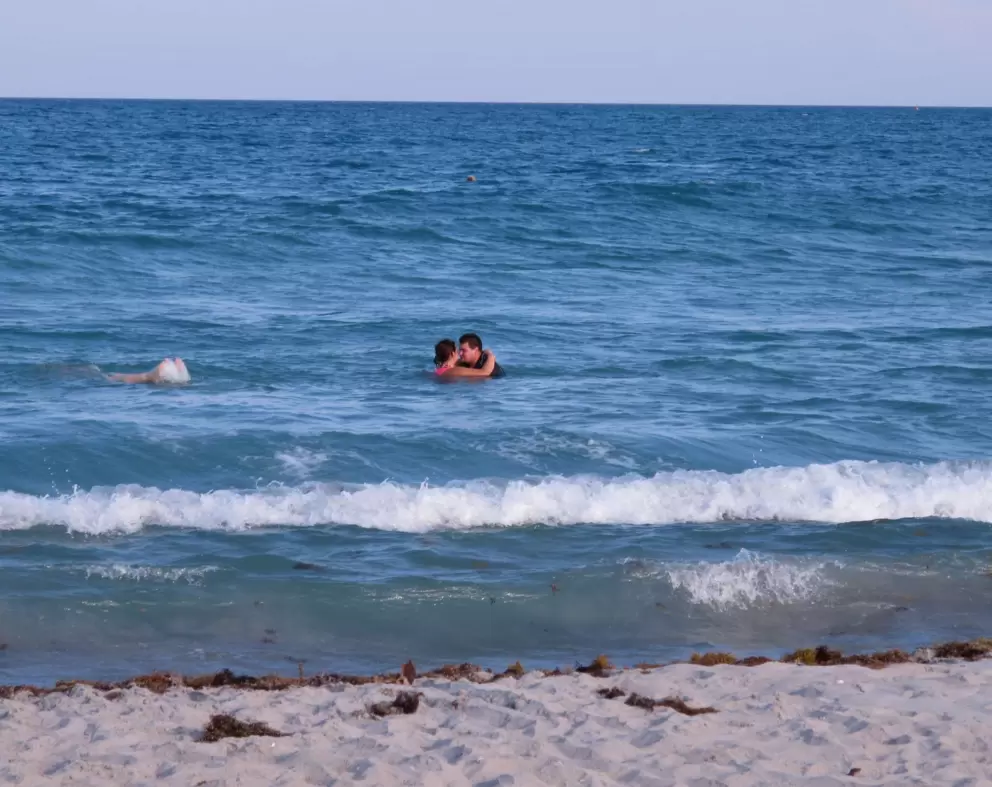 A couple enjoy a romantic swim on a Sunday evening.