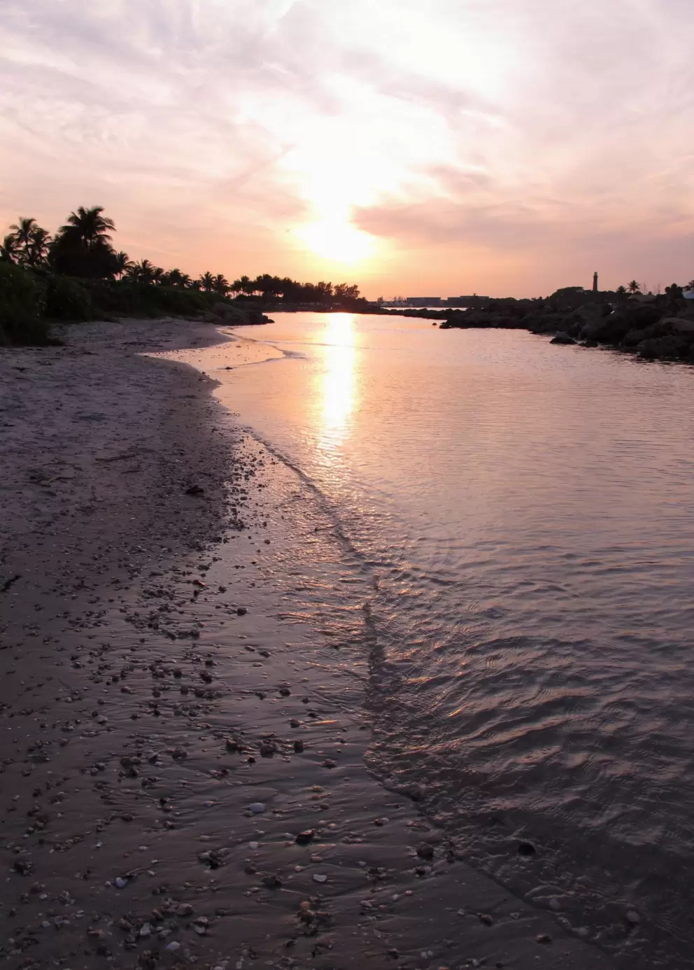 Rocks on the shore of the rock pool at sunset.