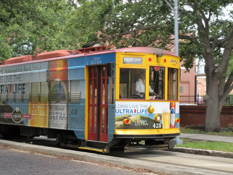 Colorful trolley car driving through Ybor City.