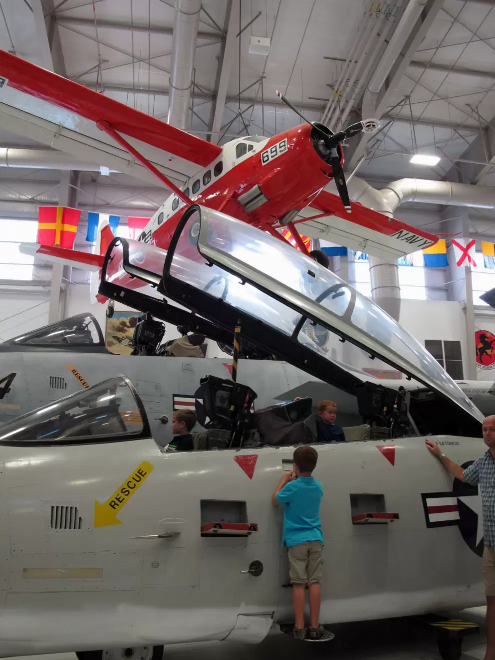 A boy checks out a plane in the second hangar.