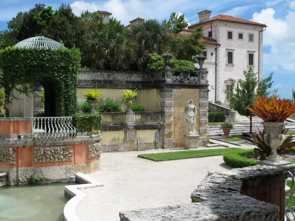 Jade-colored pool and tropical plants that catch the light make for a colorful scene. 