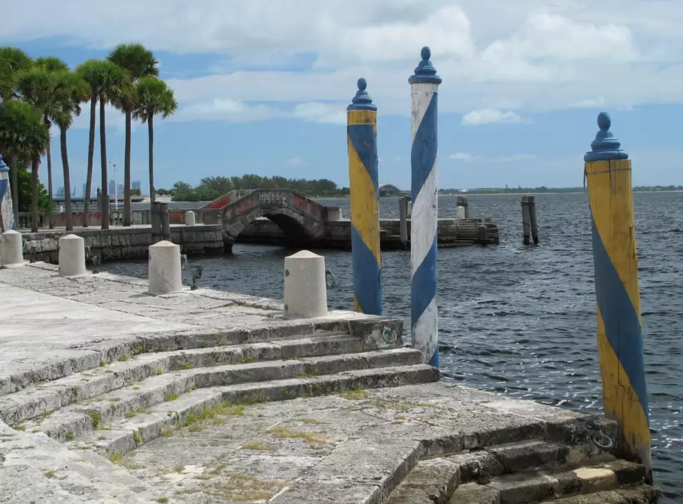 Yellow and blue striped gondola poles at the waterfront.