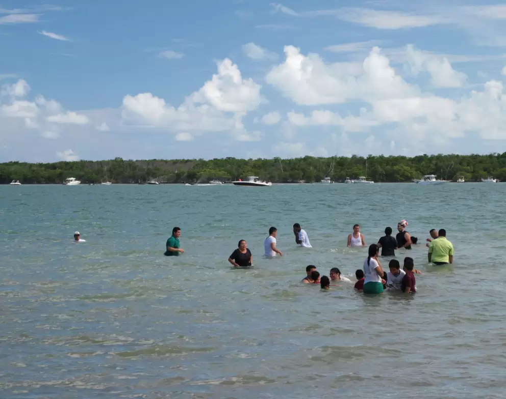 Families swimming, with Key Biscayne in the distance.