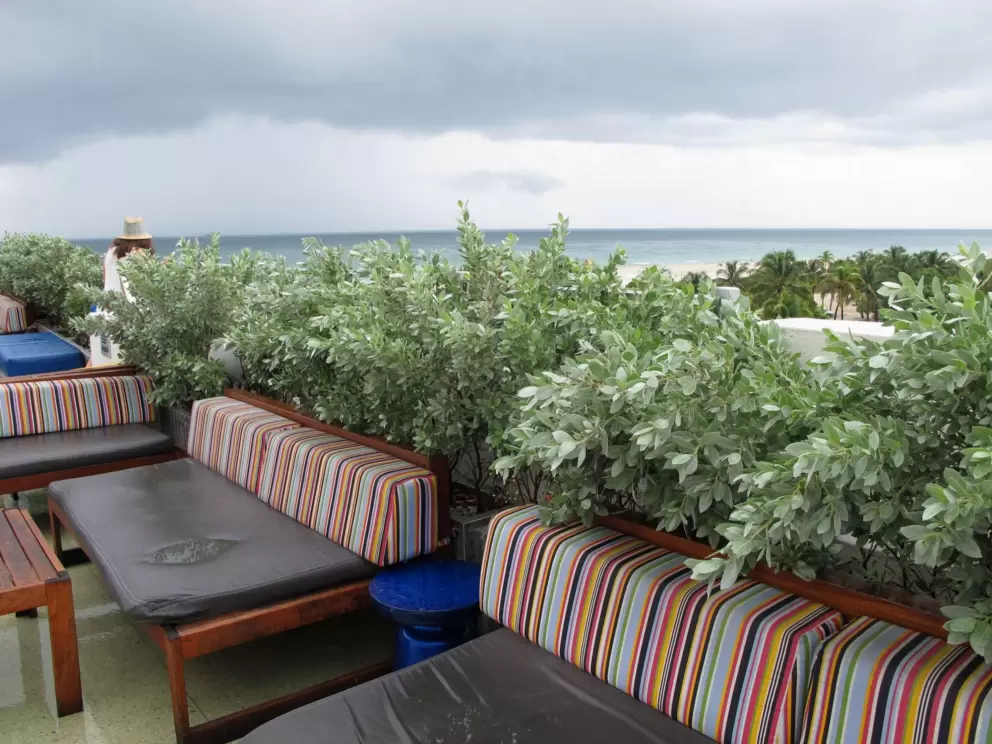 Striped multi-colored chairs and ocean view at the rooftop of the Clevelander Hotel.