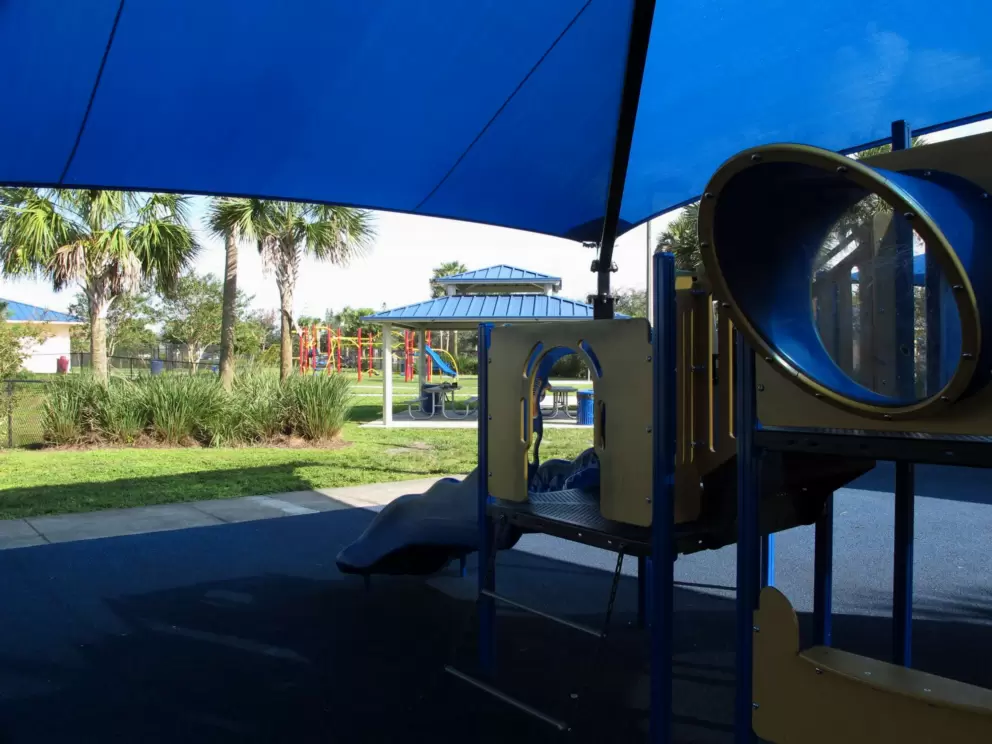 The shaded play structure and gazebo in the background.