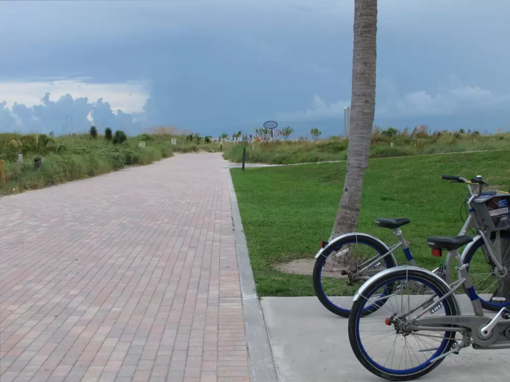 The wide brick path and Deco Bike station at South Pointe Park.