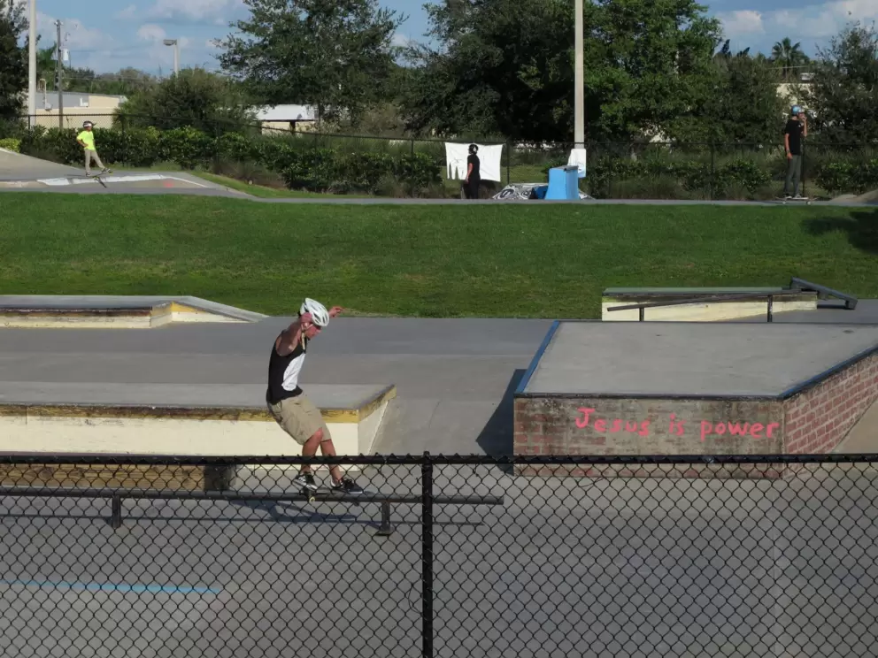 A skater does a trick at the skate park.