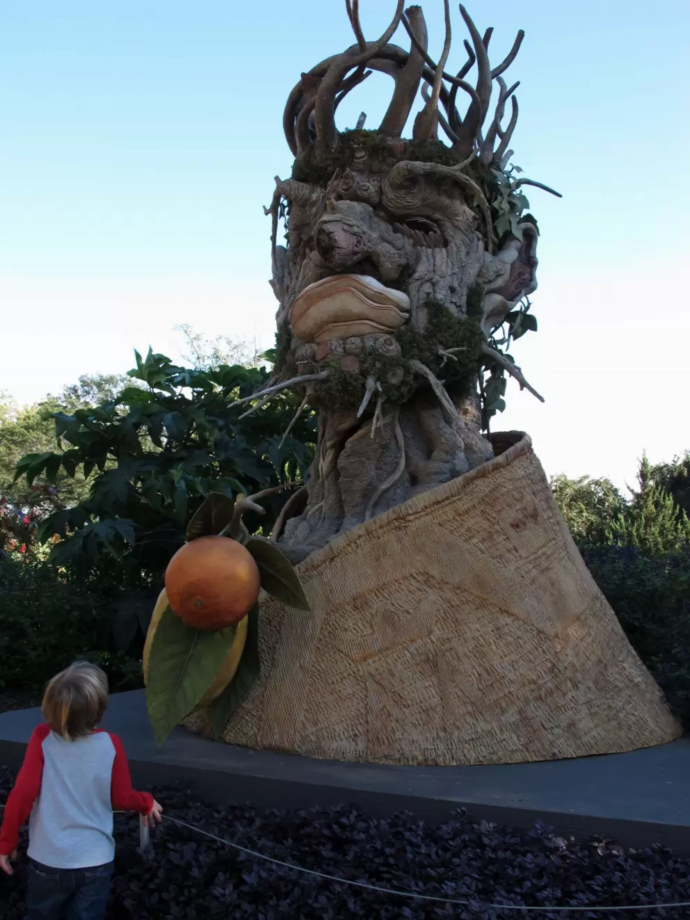 A little boy looks at the winter sculpture from Four Seasons.