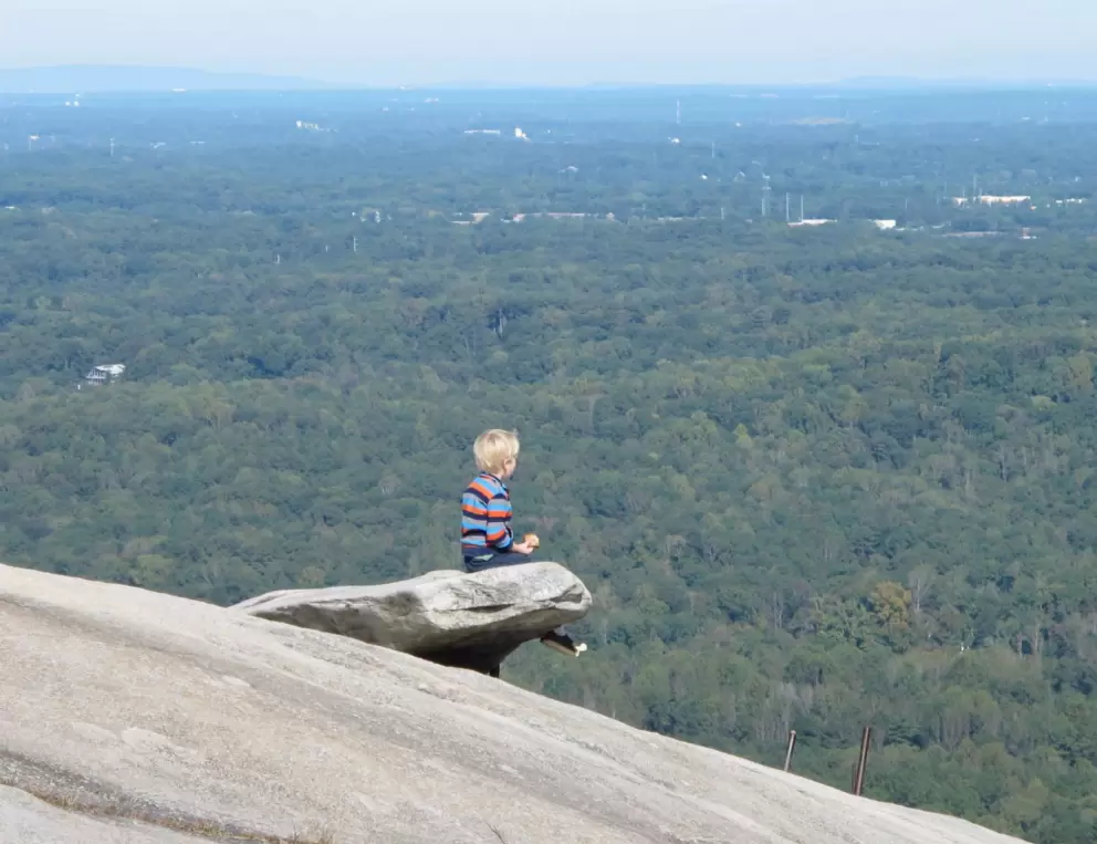 Boy on top of the world. I don't think I'd let my child do this...