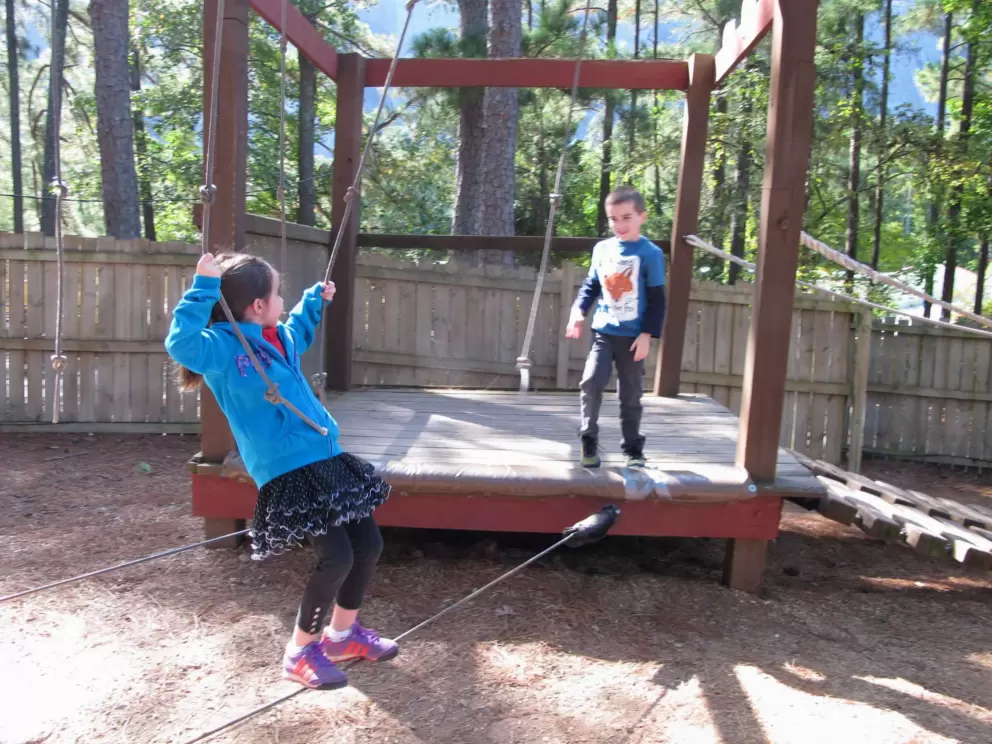 Tightrope walking at Camp Highland Outpost, behind SkyHike in the village.