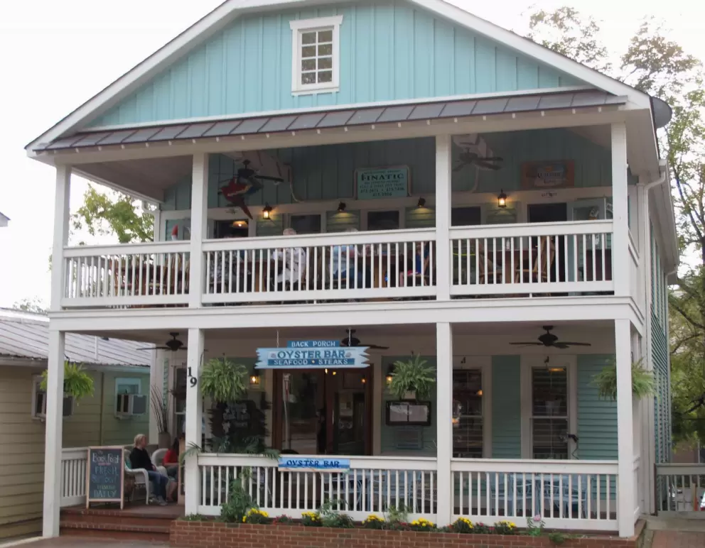 Cute architecture of Back Porch Oyster Bar, with large porch and balcony.