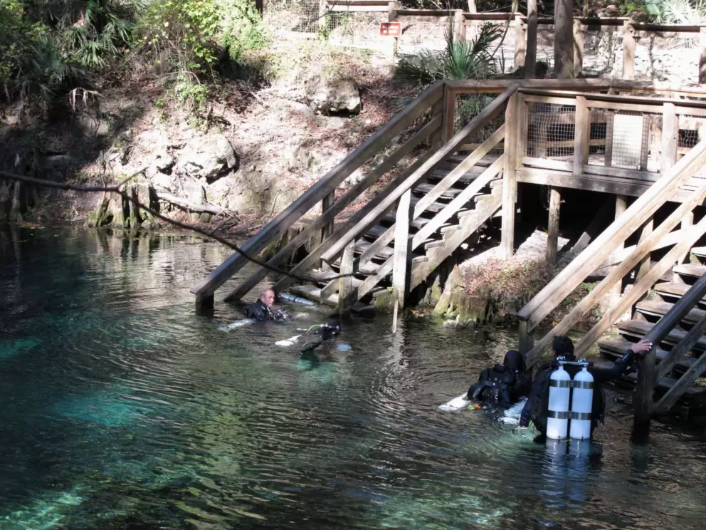 Divers by the stairs after a dive to explore the tunnels.