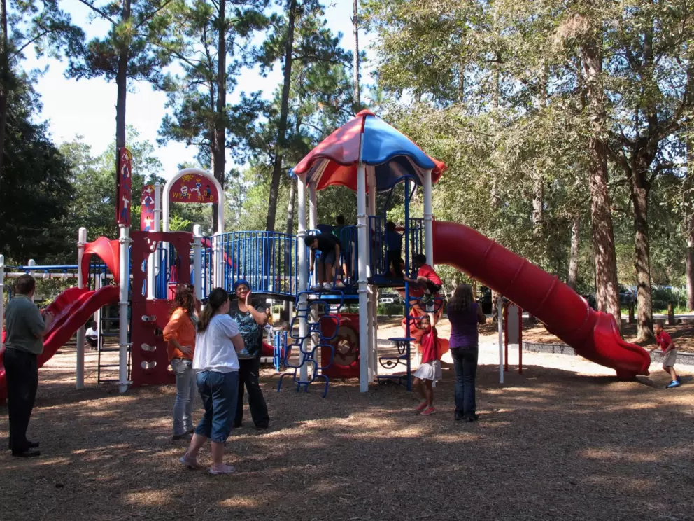 Parents chat at the toddler playground.
