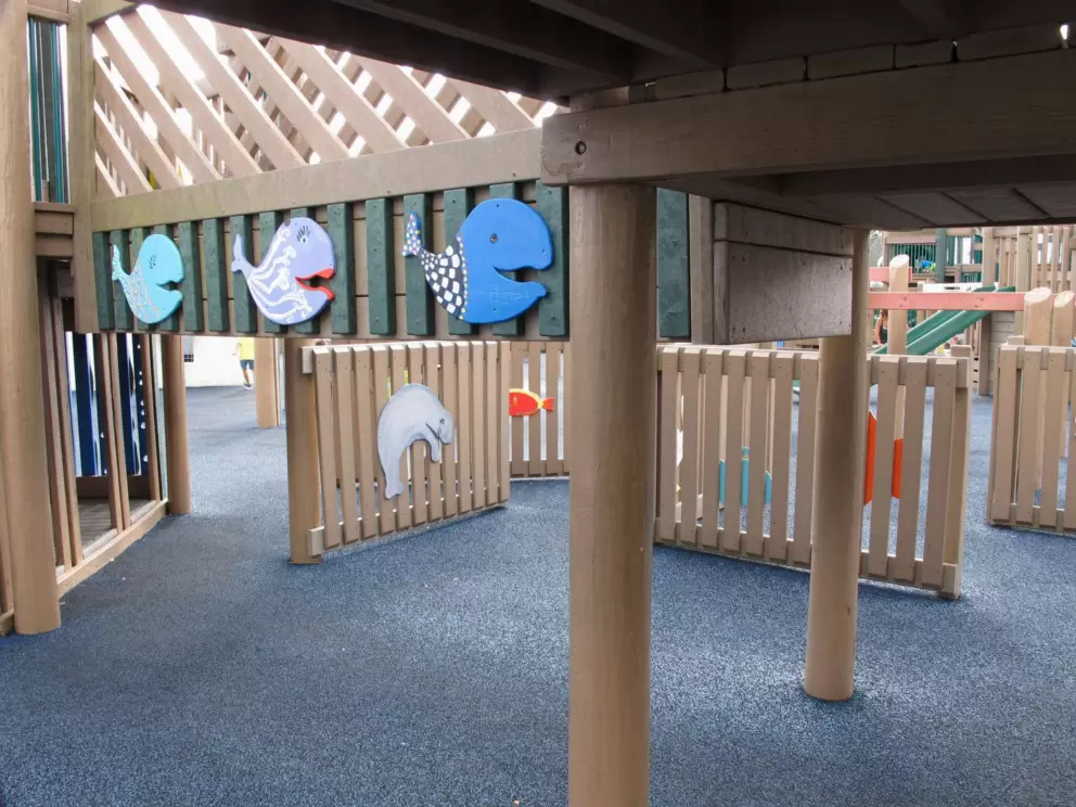 Underneath the playground with whales and manatee.