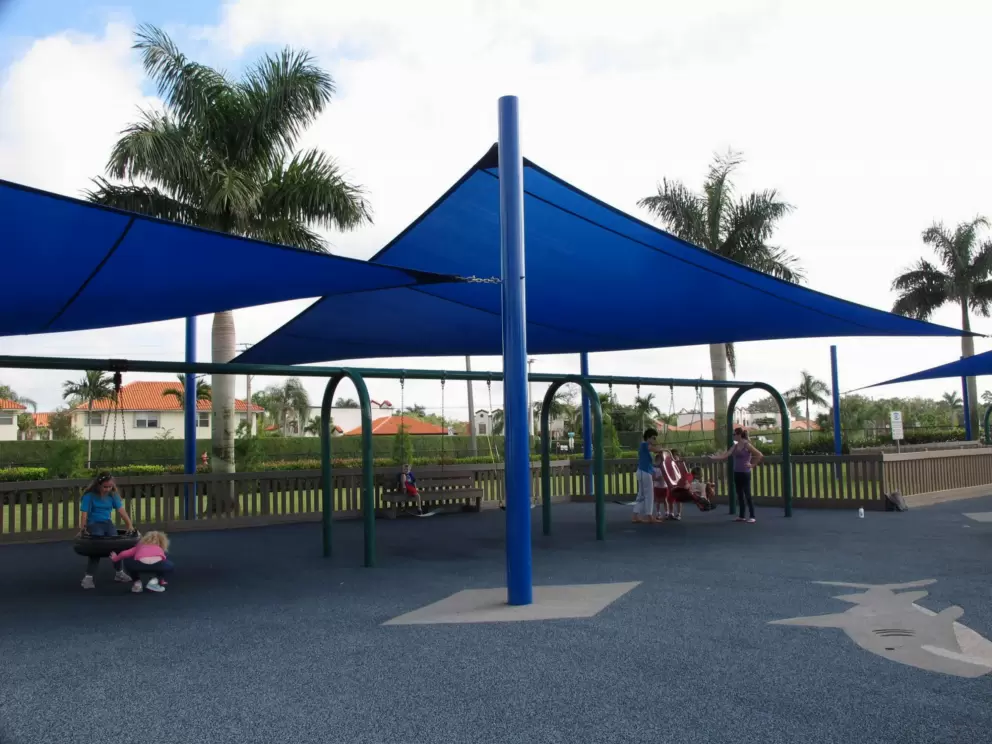 Tire swing and swings, in the shade.