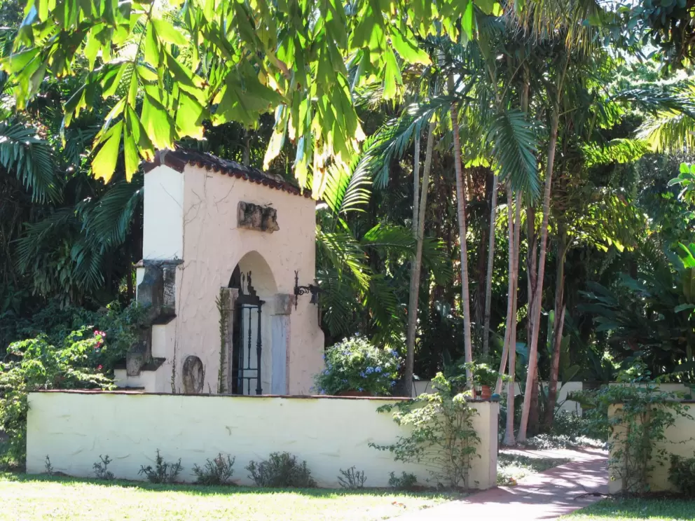 Archway and tropical foliage.