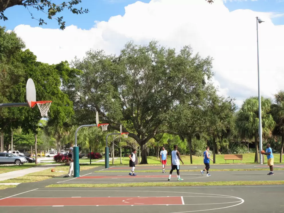 Guys enjoy a game of basketball.