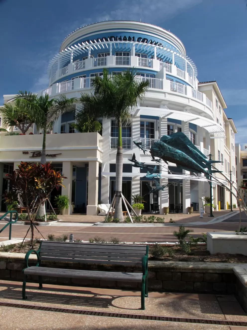 Game fish sculpture and rounded hotel front.